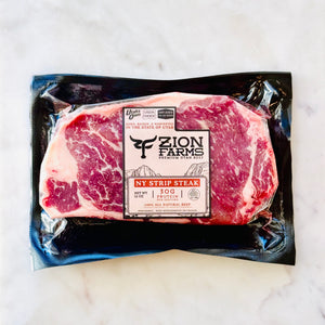 Packaged NY Strip Steak from Zion Farms on a white background