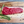 Raw steak on a wooden cutting board with rosemary and peppercorns