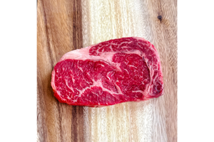 Raw steak on a wooden cutting board