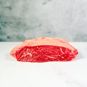 Raw steak on a white surface with a marble background