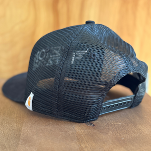 Black mesh cap on a wooden surface