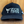 Black cap with 'Zion Farms Premium Utah Beef' logo on a wooden surface