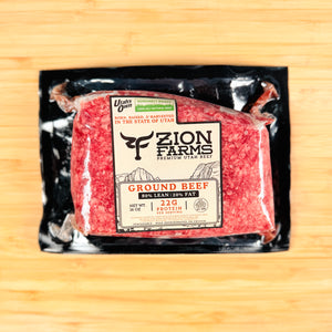 Packaged ground beef from Zion Farms on a wooden surface