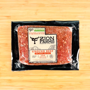 Packaged ground beef from Zion Farms on a wooden surface