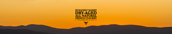 Sunset over mountains with a brand logo for dry-aged beef on an orange background