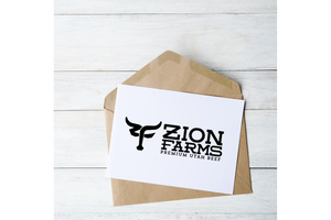 Zion Farms branded gift card on a wooden surface