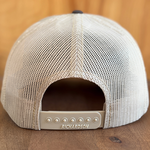 Tan mesh cap with Richardson logo on a wooden surface